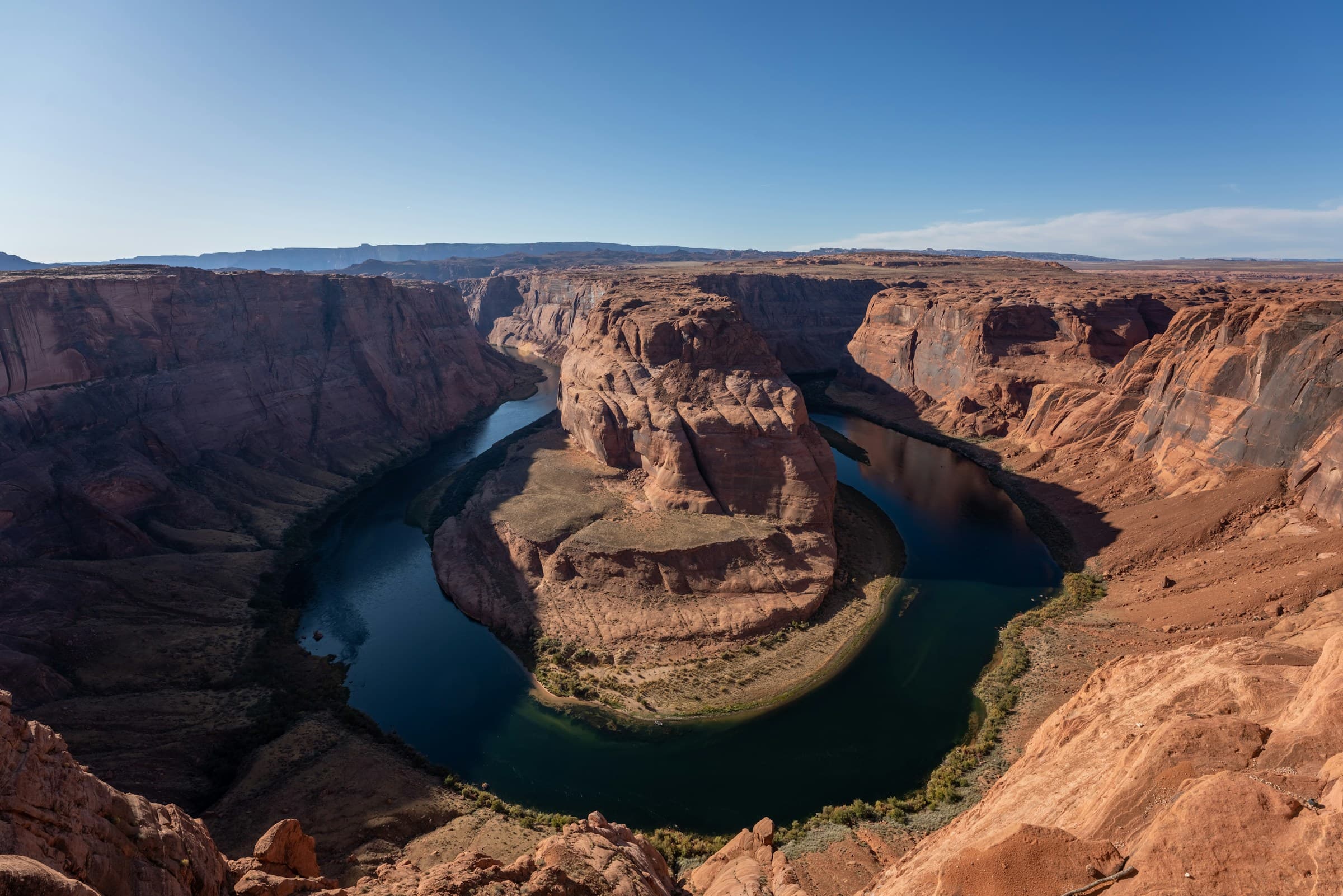The Colorado River bends through orange canyon walls at Horseshoe Bend.